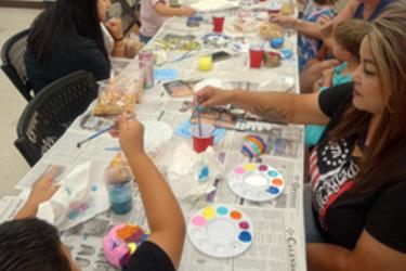 Painting rocks for William Snakespear our rock snake that lies in the garden in the front of our little library.